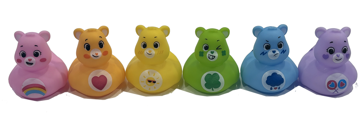 Six Care Bear-themed Rubber Ducks in pink, orange, yellow, green, blue, and purple, lined up side-by-side against a white background.
