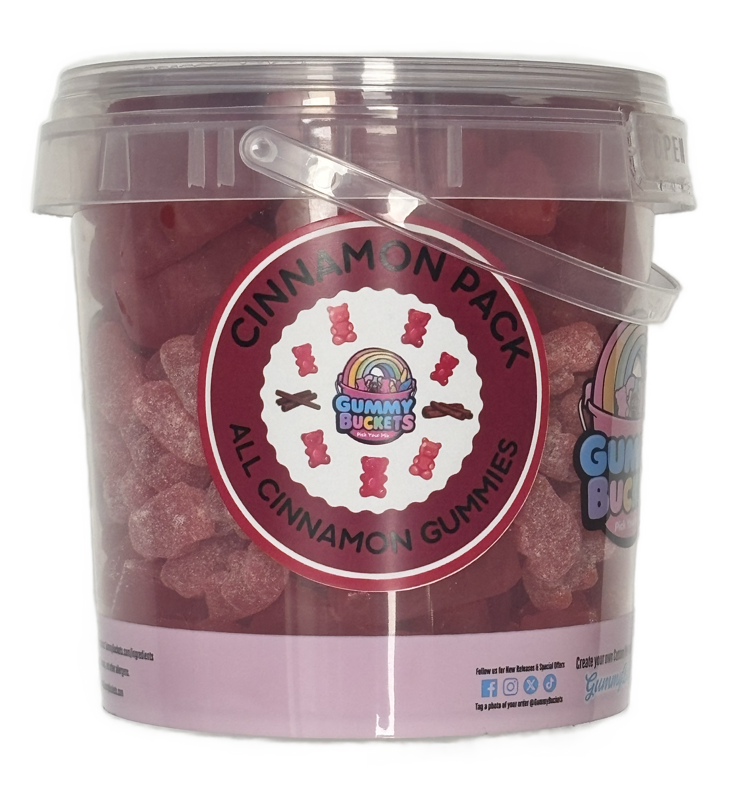 A clear plastic bucket of Gummy Buckets Cinnamon Pack gummy candies, showing the pinkish-red gummies inside, with a prominent circular red and white label on the front.