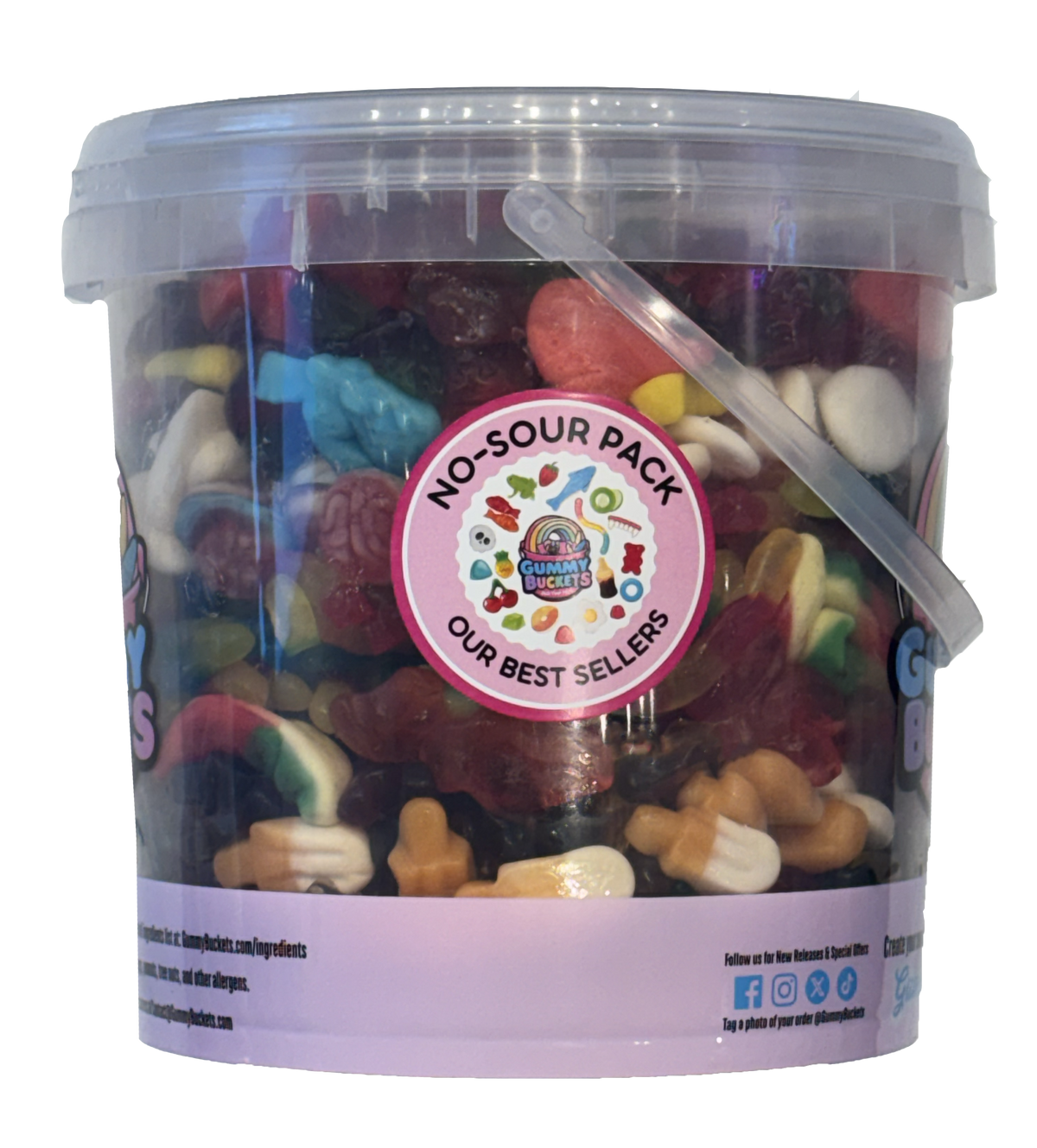 A clear plastic bucket filled with assorted colorful gummy candies and sour gummies, with a pink circular label reading 'NO-SOUR PACK OUR BEST SELLERS' and a translucent lid with a clear handle.