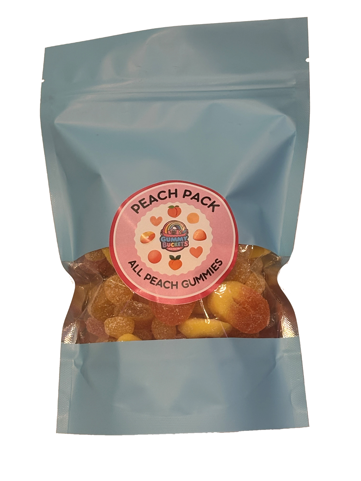 A light blue resealable stand-up pouch with a clear window showing golden peach-flavored gummy candies including rings and round peach shapes inside. A round pink label on the front reads 'PEACH PACK' and 'ALL PEACH GUMMIES' with the Gummy Buckets logo surrounded by illustrated peach and heart icons in the center.
