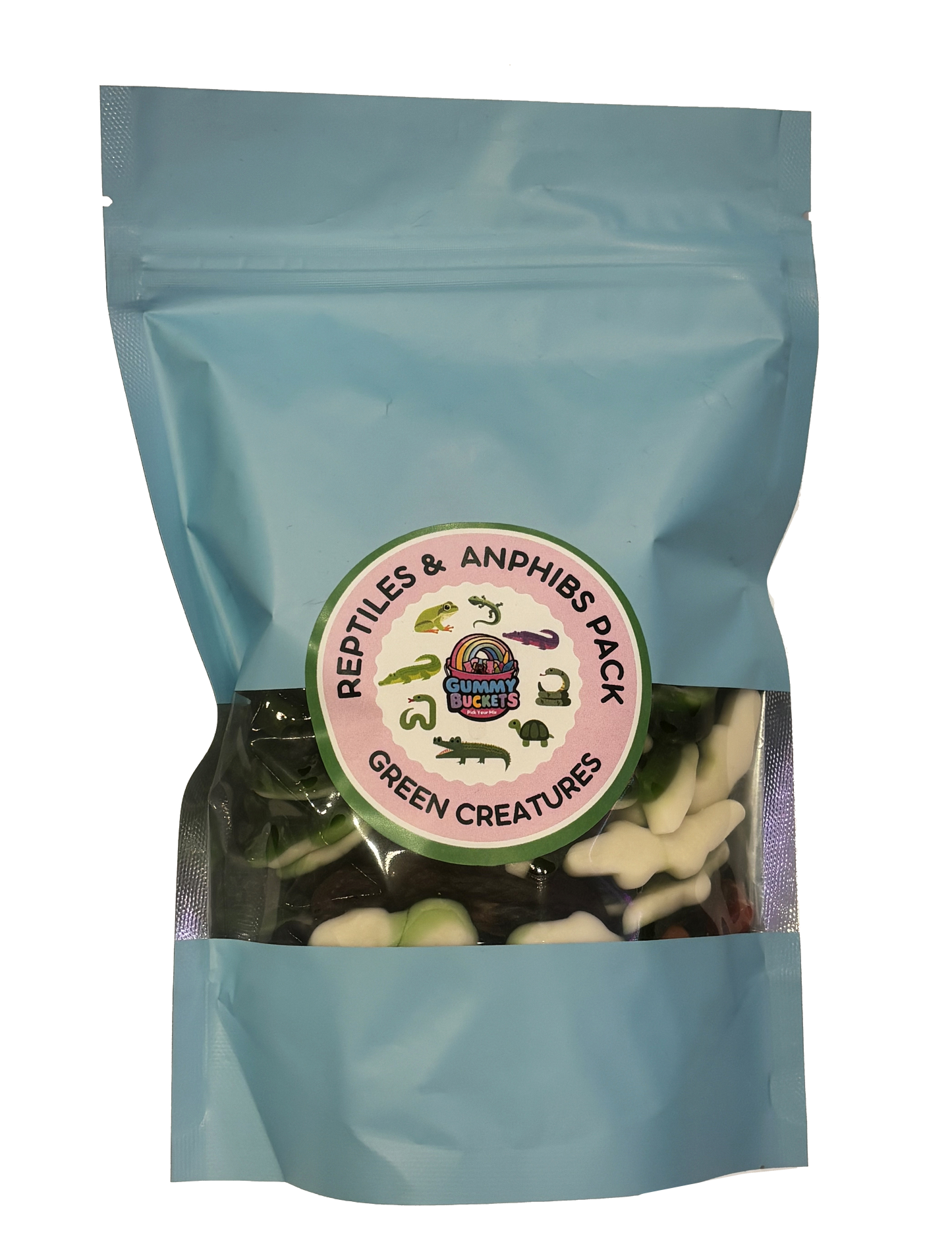 A light blue resealable stand-up pouch with a clear window showing green and white reptile and amphibian-shaped gummy candies including frogs, alligators, snakes, and turtles inside. A round green and pink label on the front reads 'REPTILES & AMPHIBS PACK' and 'GREEN CREATURES' with the Gummy Buckets logo surrounded by illustrated reptile silhouettes in the center.