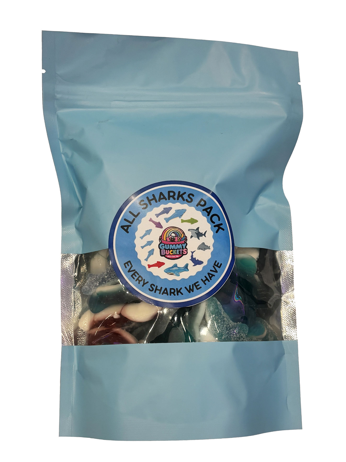 A light blue resealable stand-up pouch with a clear window showing a colorful assortment of shark-shaped gummy candies in blue, white, red, and green inside. A round blue label on the front reads 'ALL SHARKS PACK' and 'EVERY SHARK WE HAVE' with the Gummy Buckets logo surrounded by illustrated colorful shark silhouettes in the center.