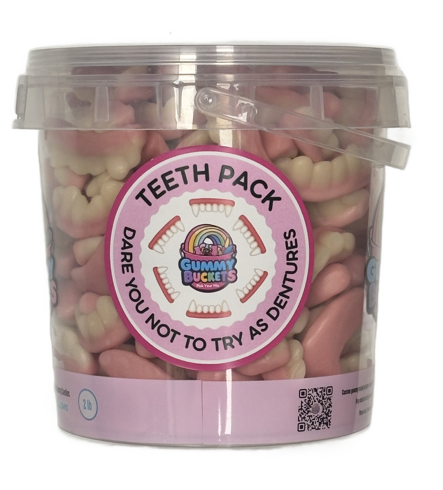 A clear plastic tub filled with pink and off-white tooth-shaped gummy candies, with a large circular pink label reading 'TEETH PACK' and the brand 'Gummy Buckets'.
