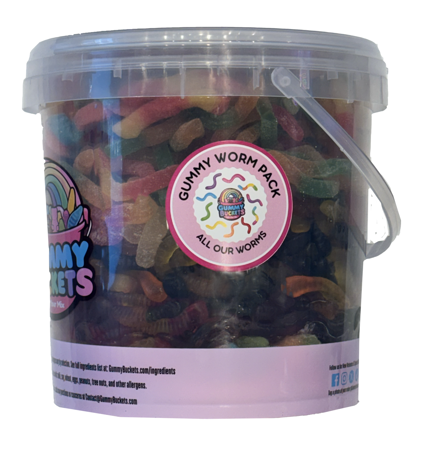 A clear plastic bucket filled with assorted gummy worms candy, featuring a pink and white label with a rainbow logo and a circular sticker that reads 'Gummy Worm Pack All Our Worms'.