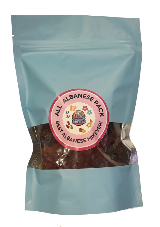 An illustrated light blue resealable bag filled with colorful Albanese gummy candies including rings, bears, and fruit shapes. A round pink label reads 'ALL ALBANESE PACK' and 'BEST ALBANESE MIX EVER!' with the Gummy Buckets logo.