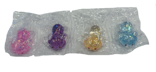 Four small glittery toy figures in clear plastic packaging, shown in pink, purple, orange, and blue on a white background.