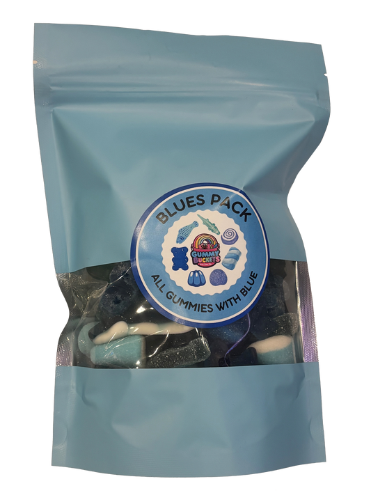 A light blue resealable stand-up pouch with a clear window showing dark blue, navy, and black gummy candies including sharks, bears, rings, and worms inside. A round blue label on the front reads 'BLUES PACK' and 'ALL GUMMIES WITH BLUE' with the Gummy Buckets logo surrounded by illustrated blue candy icons in the center.