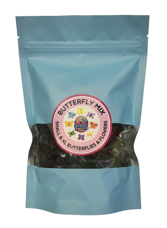 A light blue resealable stand-up pouch of candy gummies with a clear window showing colorful butterfly-shaped gummies inside. A round pink label on the front reads 'BUTTERFLY MIX' and 'SMALL & XL BUTTERFLIES & FLOWERS' with the Gummy Buckets logo in the center.