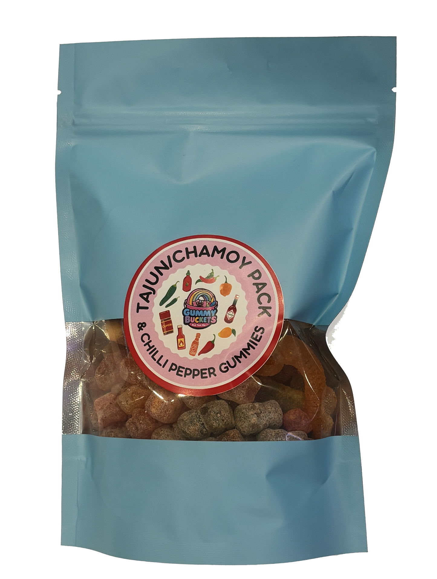 A light blue resealable stand-up pouch with a clear window showing golden and red-orange gummy bears dusted in chamoy and tajin seasoning inside. A round red and white label on the front reads 'TAJUN/CHAMOY PACK' and '& CHILLI PEPPER GUMMIES' with the Gummy Buckets logo surrounded by illustrated hot peppers, chili sauce bottles, and citrus icons in the center.