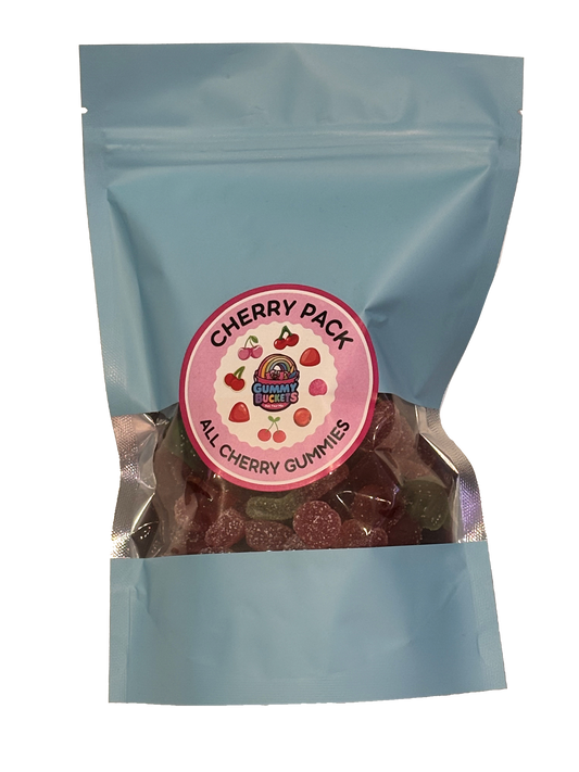 A light blue resealable stand-up pouch with a clear window showing deep red cherry-flavored gummy candies inside. A round pink label on the front reads 'CHERRY PACK' and 'ALL CHERRY GUMMIES' with the Gummy Buckets logo surrounded by illustrated cherries and strawberries in the center.
