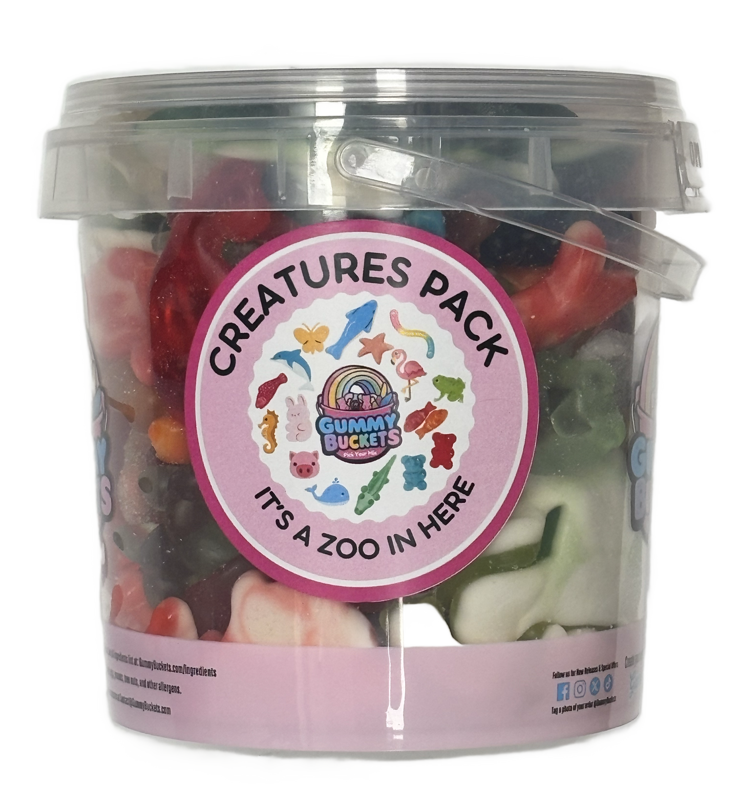 A clear plastic bucket filled with assorted gummy candies, featuring a round pink label that reads 'Creatures Pack' and 'It's a Zoo in Here' with colorful animal illustrations. The Gummy Buckets logo is visible on the label.