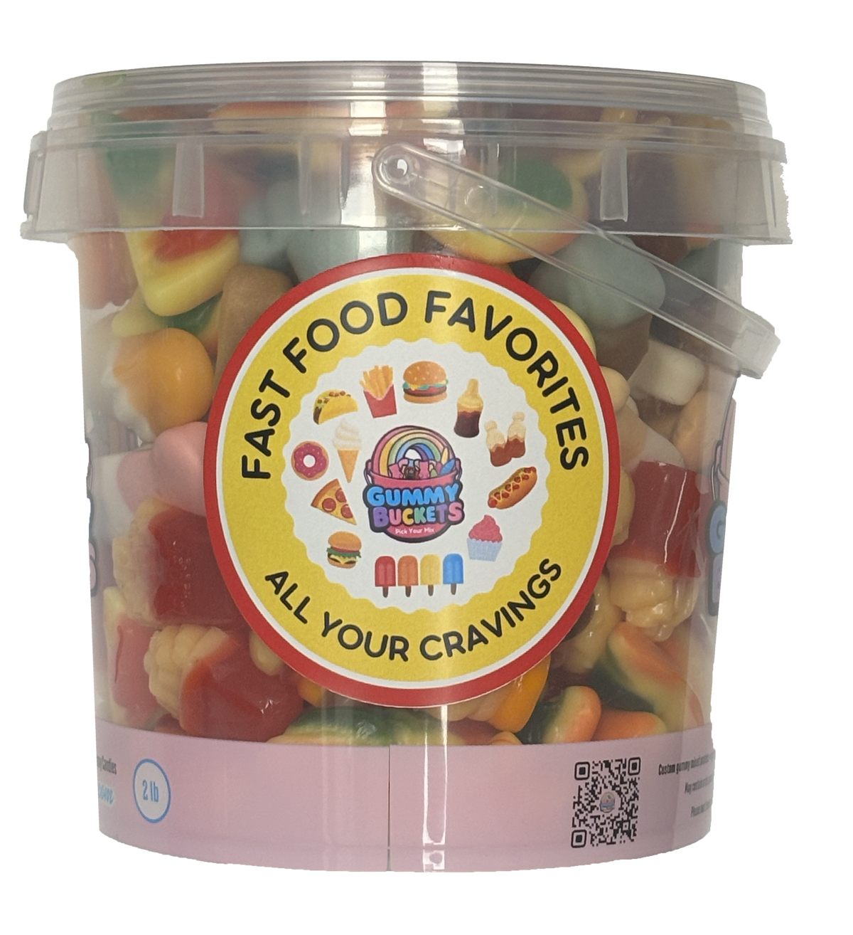 A clear plastic bucket filled with assorted gummy candies, featuring a large round yellow label that reads 'FAST FOOD FAVORITES' and 'ALL YOUR CRAVINGS' with the Gummy Bucket logo. The bucket has a translucent lid with a carrying handle and a pink base band.