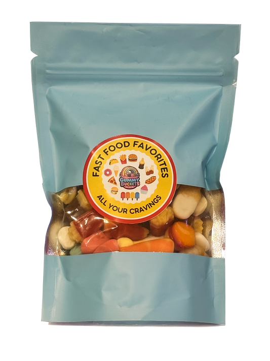 A light blue resealable stand-up pouch with a clear window showing a colorful assortment of mixed gummy candies including worms, bears, rings, and fruit shapes inside. A round pink label on the front reads 'EVERYTHING PACK' and 'FIND A NEW FAVORITE' with the Gummy Buckets logo surrounded by illustrated candy icons in the center.
