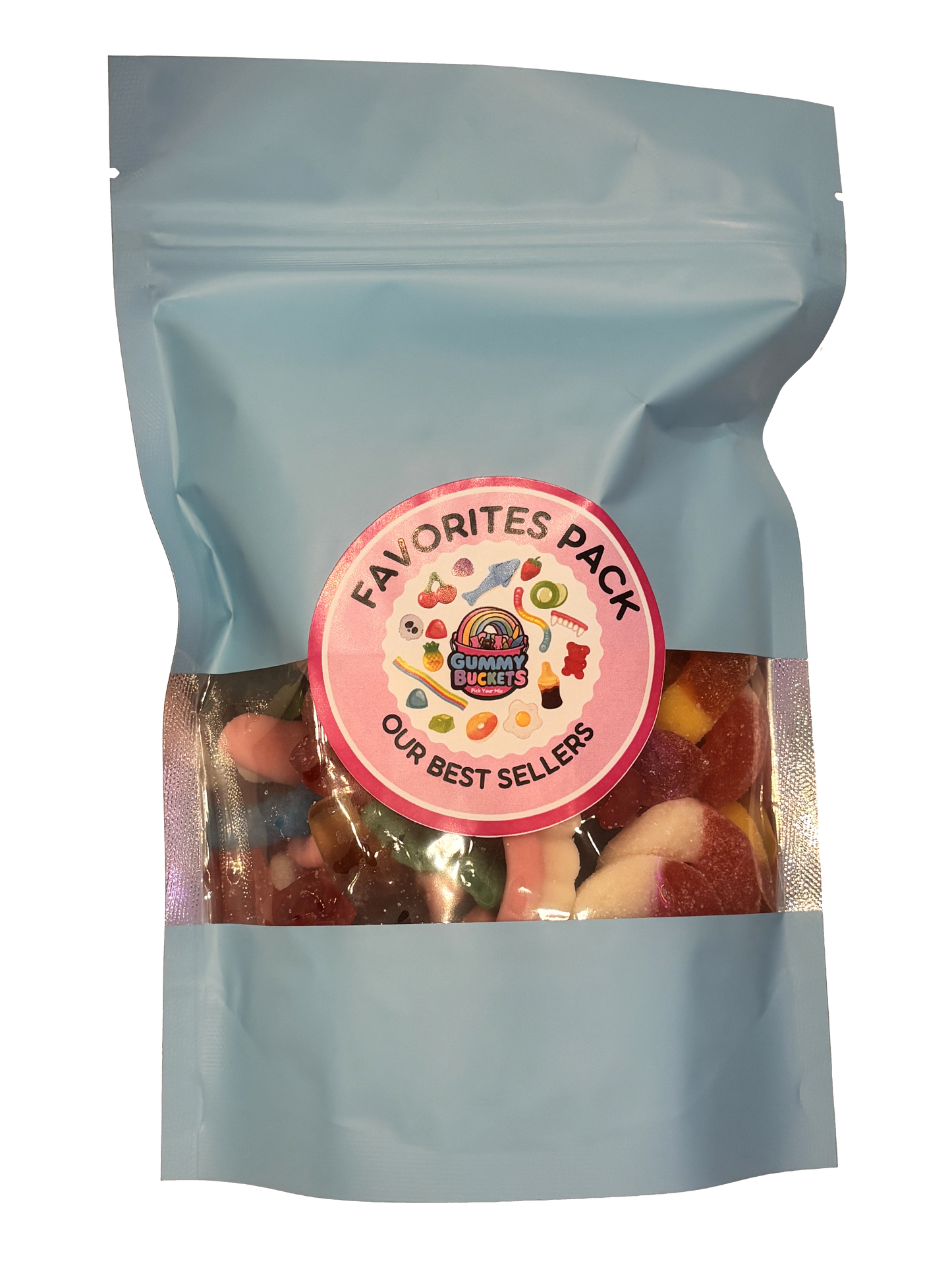 A light blue resealable stand-up pouch with a clear window showing a colorful assortment of best-selling gummy candies including worms, bears, peach rings, and fruit shapes inside. A round pink label on the front reads 'FAVORITES PACK' and 'OUR BEST SELLERS' with the Gummy Buckets logo surrounded by illustrated candy icons in the center.