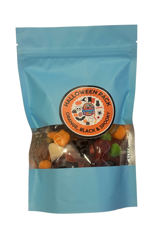 A light blue stand-up pouch of Halloween gummy candy mix with a clear window showing orange, black, and green gummies inside. The front has a circular orange label reading 'HALLOWEEN PACK ORANGE, BLACK & SPOOKY' with a cartoon witch logo.