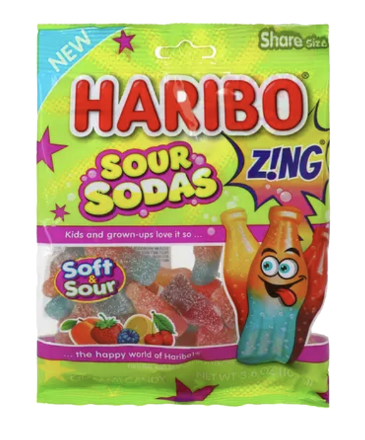 Green HARIBO Sour Sodas bag with colorful bottle-shaped gummies visible through its window.