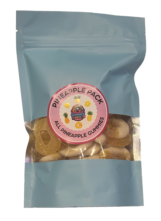 A light blue stand-up pouch of pineapple gummy candies with a clear window showing the gummies inside. A round pink label on the front reads 'PINEAPPLE PACK' and 'ALL PINEAPPLE GUMMIES' with a small 'Gummy World' logo.