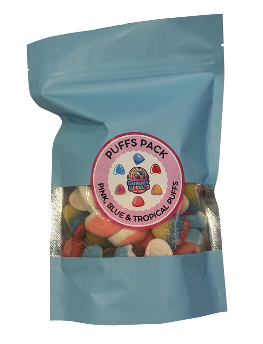 A light blue resealable stand-up pouch containing assorted colorful candy puffs, with a round pink label reading 'Puffs Pack' and 'Pink, Blue & Tropical Puffs.'.