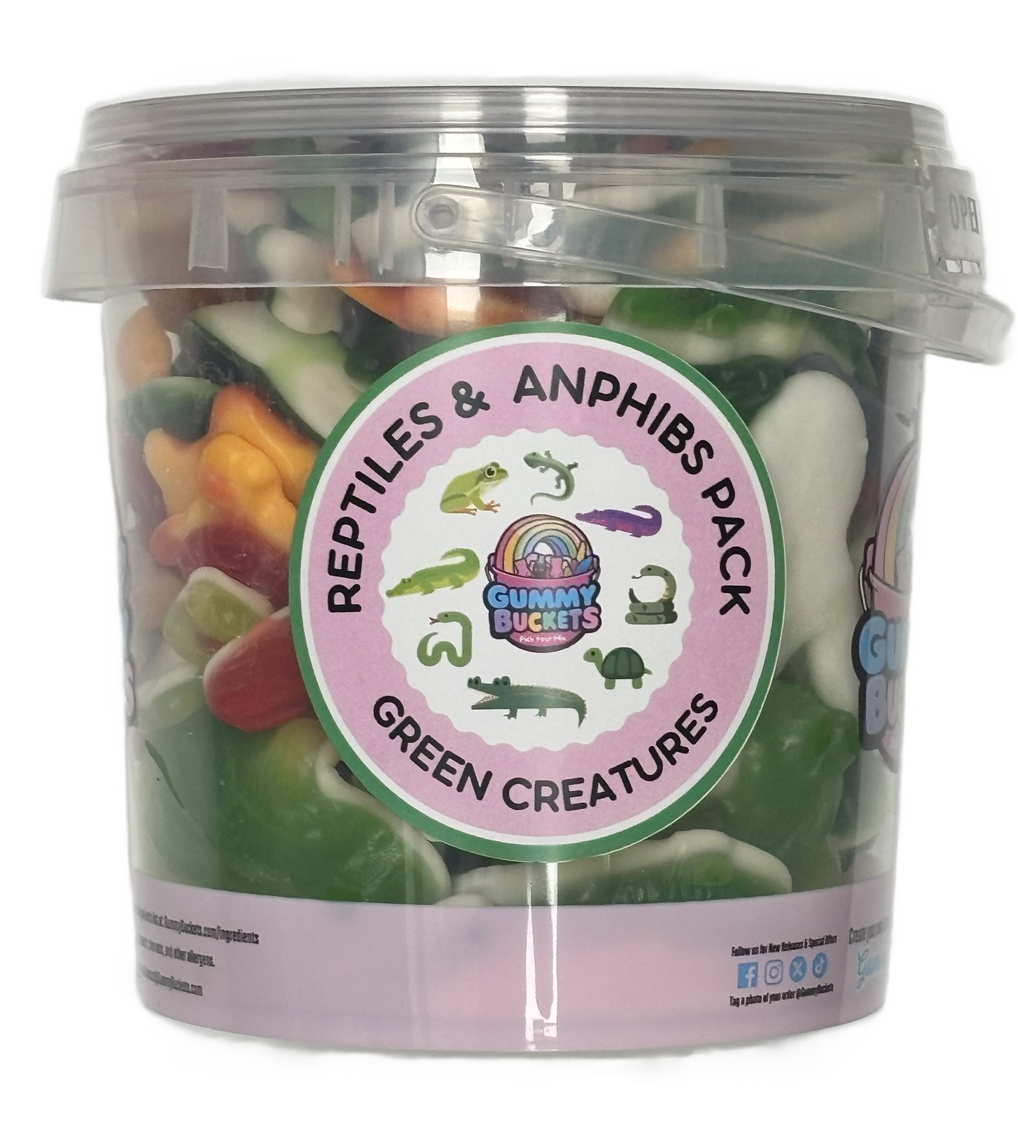 A clear plastic bucket filled with assorted gummy candies, featuring a round pink label that reads 'Reptiles & Amphibs Pack' and 'Green Creatures,' with cartoon reptile and amphibian illustrations. The bucket is photographed on a plain white background.