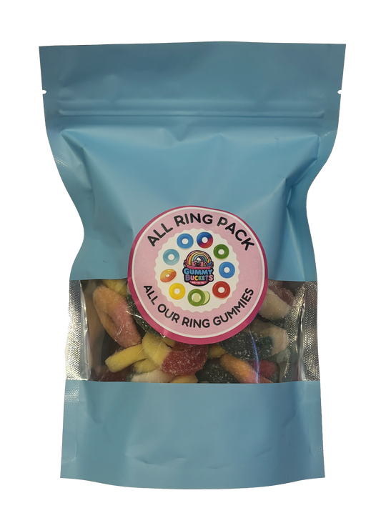 A light blue resealable stand-up pouch with a clear window showing a colorful assortment of ring-shaped gummy candies in red, yellow, green, blue, and black inside. A round pink label on the front reads 'ALL RING PACK' and 'ALL OUR RING GUMMIES' with the Gummy Buckets logo surrounded by illustrated colorful gummy rings in the center.