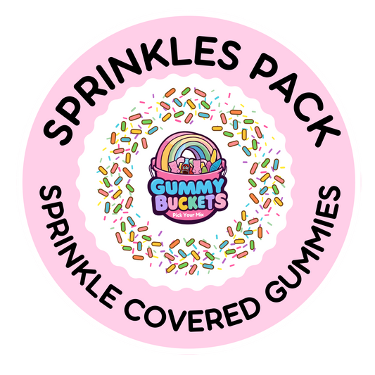 A circular pink label for a 'Sprinkles Pack' by Gummy Buckets, featuring the text 'SPRINKLES PACK' and 'SPRINKLE COVERED GUMMIES' in black around a central illustration of a rainbow and gummy bear in a bucket surrounded by colorful sprinkles.