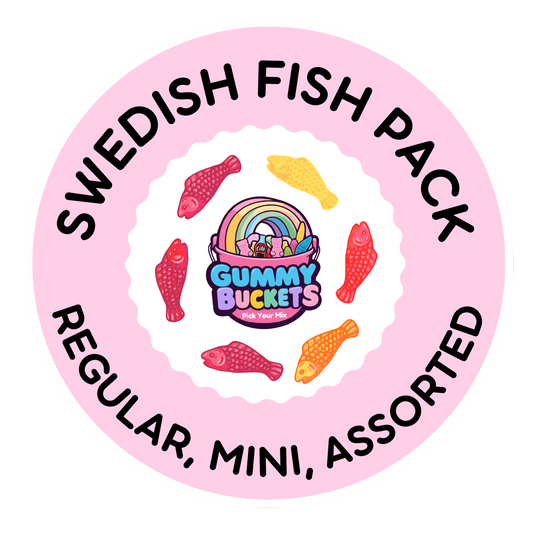 A circular pink label for a 'Swedish Fish Pack' containing assorted gummy candies. The label features the text 'SWEDISH FISH PACK' and 'REGULAR, MINI, ASSORTED' in black lettering, surrounding a central logo that reads 'Gummy Buckets' with a rainbow and fish illustrations.