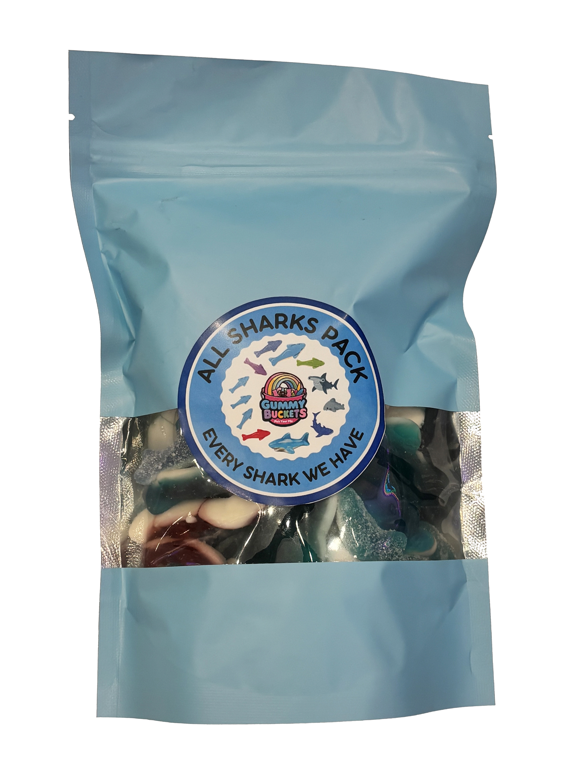 A light blue resealable stand-up pouch with a clear window showing a colorful assortment of shark-shaped gummy candies in blue, white, red, and green inside. A round blue label on the front reads 'ALL SHARKS PACK' and 'EVERY SHARK WE HAVE' with the Gummy Buckets logo surrounded by illustrated colorful shark silhouettes in the center.