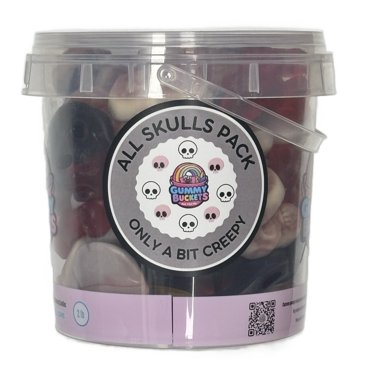 A clear plastic bucket filled with assorted gummy candies, featuring a large circular label that reads 'ALL SKULLS PACK' and 'ONLY A BIT CREEPY' with the Gummy Buckets logo. The bucket has a translucent lid and a clear side handle, set against a plain white background.