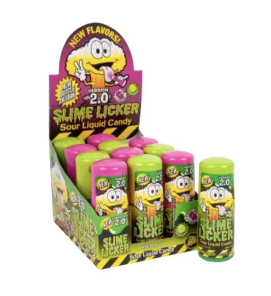 A retail display box and individual bottles of 'Slime Licker' sour liquid candy, featuring a cartoon slime character on the packaging and bright lime green, pink, and lime green candy containers.