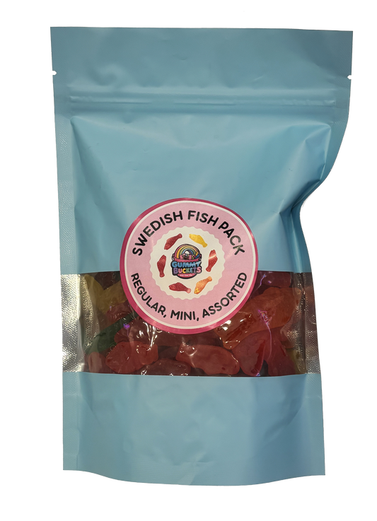 A light blue resealable stand-up pouch with a large clear window showing a generous assortment of red, pink, and yellow Swedish Fish-shaped gummy candies in regular and mini sizes inside. A round pink label on the front reads 'SWEDISH FISH PACK' and 'REGULAR, MINI, ASSORTED' with the Gummy Buckets logo surrounded by illustrated Swedish Fish icons in the center.