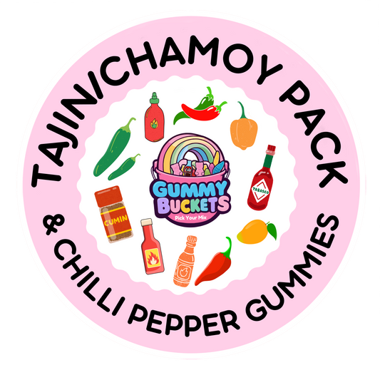 A circular pink graphic for a 'Tajinichamoy Pack' featuring illustrated hot peppers, chili sauce bottles, a cumin jar, a Tabasco bottle, a mango, and a rainbow-themed 'Gummy Buckets' bucket, with text reading 'TAJINICHAMOY PACK' and '& CHILLI PEPPER GUMMY GUMMS'.