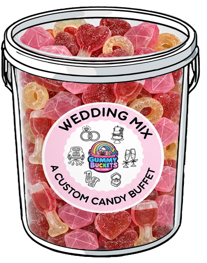 A large clear plastic tub filled with assorted gummy candies, including pink heart-shaped gummies, red ring gummies, and orange loop gummies, with a white lid. The front has a round pink label reading 'WEDDING MIX' and 'A CUSTOM CANDY BUFFET' with the Gummy Buckets logo.