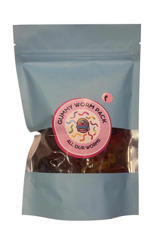 A light blue stand-up pouch of gummy worms candy with a clear window showing the colorful gummies inside. A circular pink and white label on the front reads 'GUMMY WORM PACK' and 'ALL OUR WORKS'.